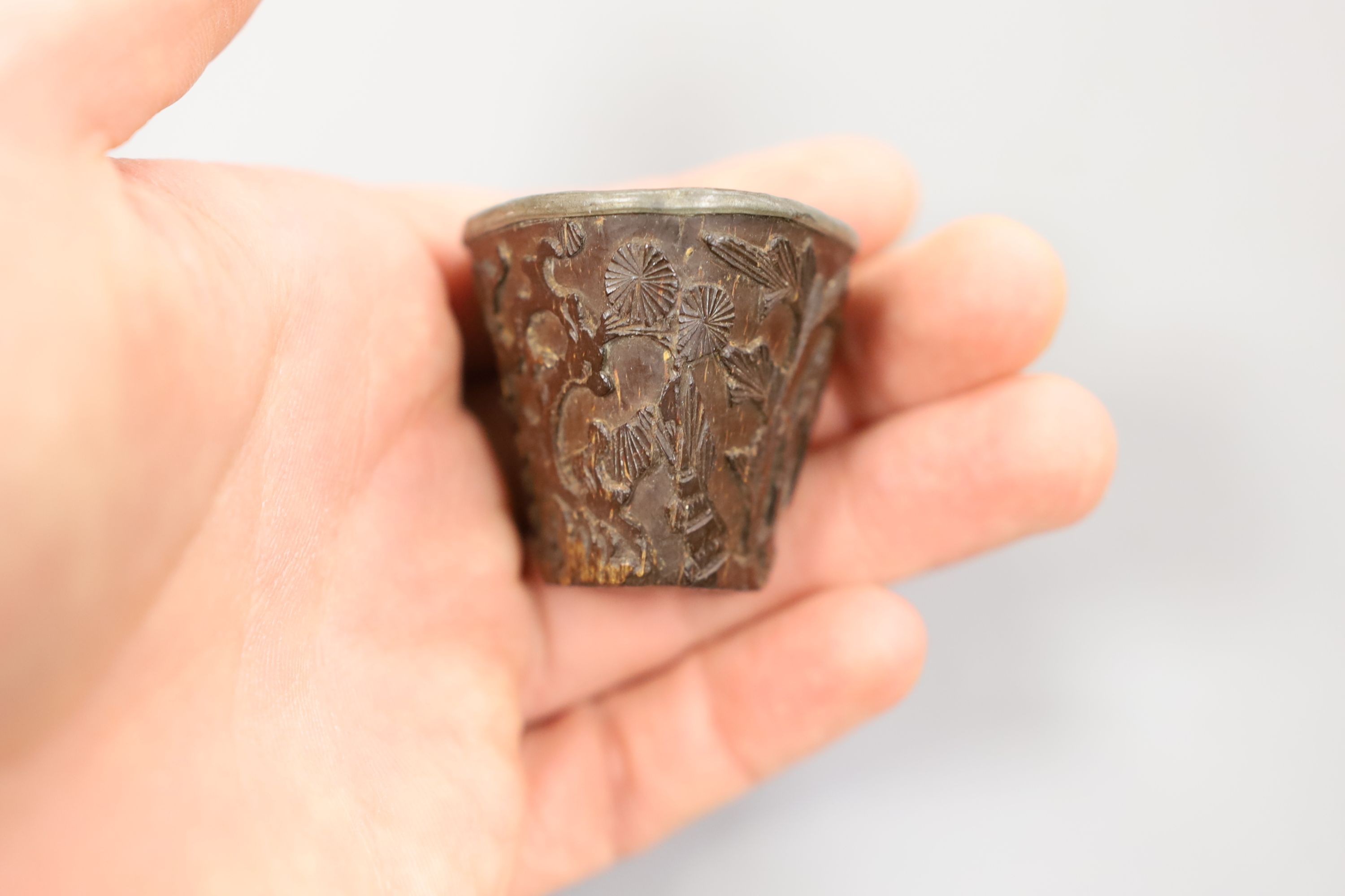 A Chinese or Japanese ivory lion dog 18th/19th century and a Chinese carved nut cup, 19th century. 4cm